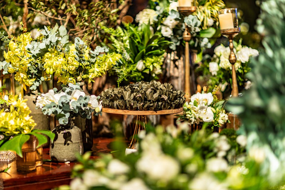 A lush display of green foliage and white flowers as a wedding table decoration.